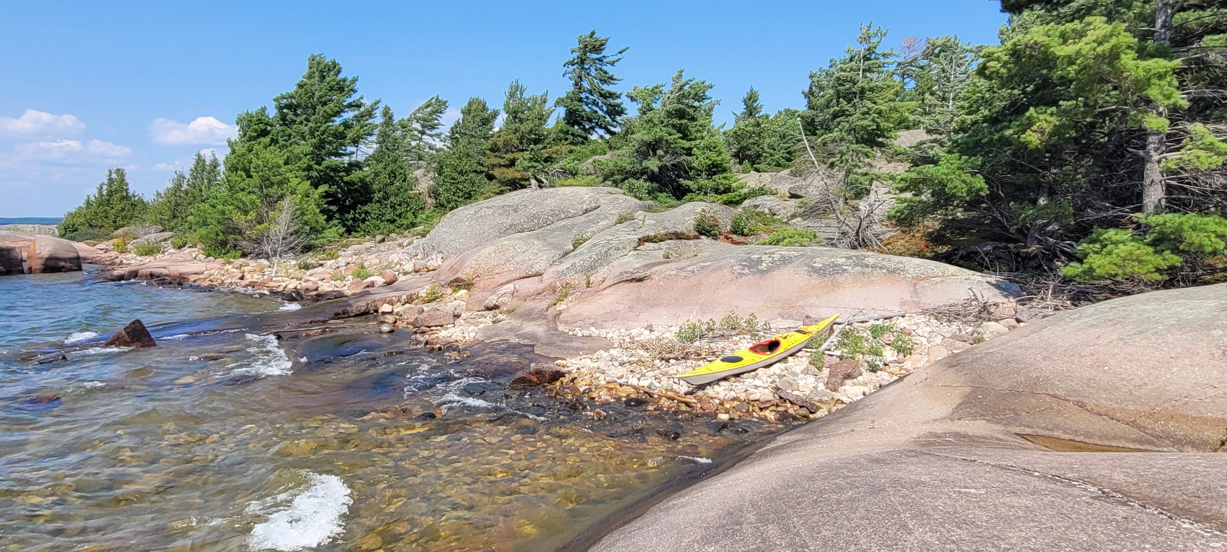 View from Benjamin Island of an island chain leading to it from Fox Island with the La Cloche mountains in the distance, in Lake Huron, Ontario, Canada